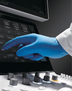 Veterinarian using portable veterinary ultrasound on a dog